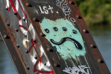  Two-faced graffiti on a bridge