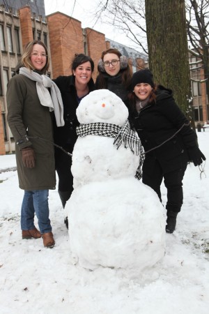 Julie Smitka, Jen Bonder, Kristina, and Mary Triny Mena with a snowman in the Massey College quad