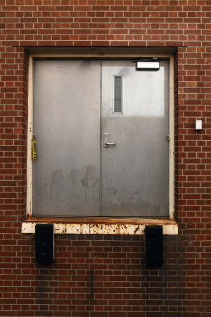 Metal door in brick wall