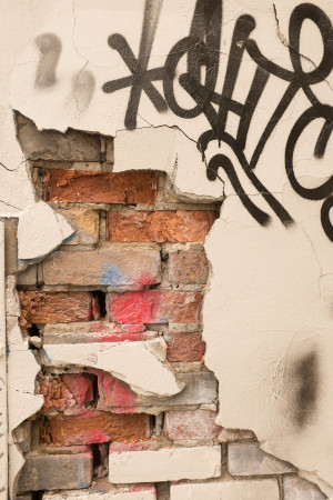 Bricks behind cracked wall